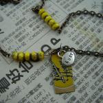 Interspersed yellow matte picasso czech beads with "lust" charm and yellow bottlecap pendant. SOLD